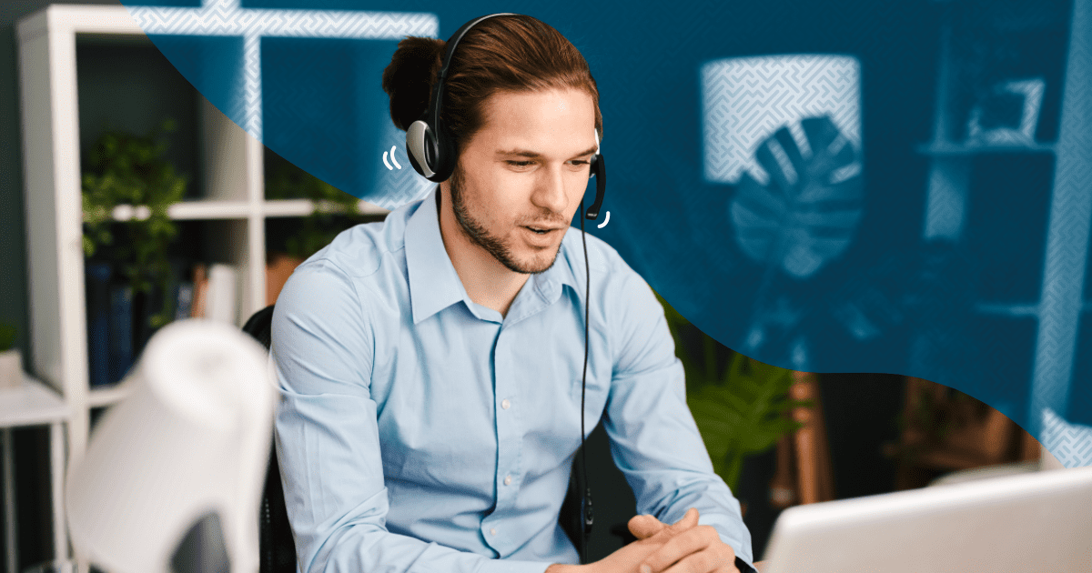 Man working at computer wearing headphones - A Small Business' Guide to Choosing The Best Customer Service Solution