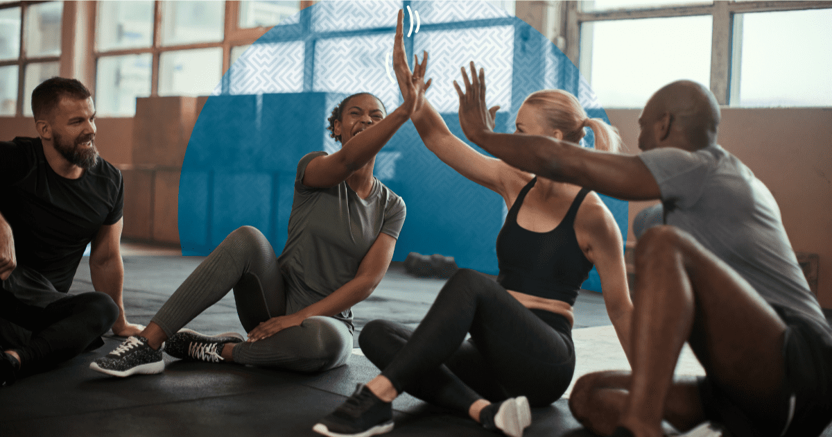 New Year, New Members: Group of Gym members giving high fives - How to Use Texting to Boost Gym Engagement and Retention